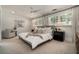 Bright main bedroom featuring carpet, large windows, ceiling fan, and neutral walls create a serene retreat at 583 Etowah Ne Dr, Marietta, GA 30060