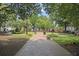 Brick path leading to a fountain, manicured lawns, trees and benches in the park at 583 Etowah Ne Dr, Marietta, GA 30060