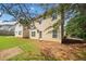 Home's backyard showing a small, square patio and a green lawn with some trees at 181 Ridgemont Rd, Canton, GA 30114