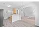 Bright dining area featuring wood floors, modern chandelier, and open access to living room and kitchen at 181 Ridgemont Rd, Canton, GA 30114