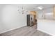 Dining area with gray wood flooring, stainless steel refrigerator and chandelier at 181 Ridgemont Rd, Canton, GA 30114