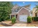 Two-story home featuring a brick facade, attached garage, and well-kept landscaping at 181 Ridgemont Rd, Canton, GA 30114
