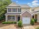 Two-story home with brick facade, attached garage, and manicured landscaping at 181 Ridgemont Rd, Canton, GA 30114