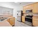 Kitchen with stainless steel appliances, wood cabinets, wood flooring, and a breakfast bar at 181 Ridgemont Rd, Canton, GA 30114