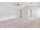Spacious main bedroom featuring plush carpet, ceiling fan, and ensuite bathroom at 181 Ridgemont Rd, Canton, GA 30114