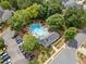 Aerial view of a community pool surrounded by lush greenery and a clubhouse at 181 Ridgemont Rd, Canton, GA 30114