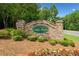 Stone entrance sign for Canton Heights, surrounded by landscaping and flowers at 181 Ridgemont Rd, Canton, GA 30114