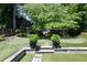 This backyard features an artificial putting green and lush landscaping at 204 Rumson Ne Rd, Atlanta, GA 30305