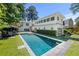Expansive backyard pool area with a large pool, manicured lawn, and outdoor seating at 204 Rumson Ne Rd, Atlanta, GA 30305