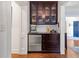 Convenient bar area with custom cabinets, a wine cooler, and stylish glassware storage at 204 Rumson Ne Rd, Atlanta, GA 30305