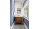 Stylish powder room with modern vanity, blue walls, and patterned tile floor at 204 Rumson Ne Rd, Atlanta, GA 30305
