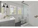 White tiled bathroom featuring a glass shower, modern vanity, and patterned floor at 204 Rumson Ne Rd, Atlanta, GA 30305