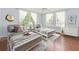 Airy bedroom showcasing two beds, hardwood floors, natural light, and calming neutral tones for relaxation at 204 Rumson Ne Rd, Atlanta, GA 30305