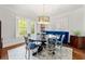 Elegant dining room with a round table, modern lighting, and large windows with plantation shutters at 204 Rumson Ne Rd, Atlanta, GA 30305