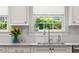 Bright kitchen with white cabinets, marble countertops, and a view of the backyard at 204 Rumson Ne Rd, Atlanta, GA 30305