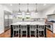 Bright kitchen featuring stainless steel appliances, a marble island with seating, and custom white cabinetry at 204 Rumson Ne Rd, Atlanta, GA 30305