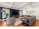 Stylish living room with hardwood floors, a comfortable couch, and a view of the backyard at 204 Rumson Ne Rd, Atlanta, GA 30305
