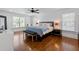 Large bedroom with hardwood floors, a ceiling fan, and a bench at the end of the bed at 204 Rumson Ne Rd, Atlanta, GA 30305