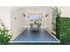 Inviting outdoor patio with patterned tile floor, white brick walls, and lush greenery at 204 Rumson Ne Rd, Atlanta, GA 30305
