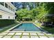 Backyard pool with stone tile surround, green grass, and ample space for lounging in the sun at 204 Rumson Ne Rd, Atlanta, GA 30305