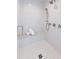 Elegant shower with white tile, a rainfall showerhead, and a built-in bench at 204 Rumson Ne Rd, Atlanta, GA 30305