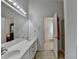 Bright bathroom with double sinks, large mirror, access to the bedroom, and walk-in shower at 2790 Meadow Gate Way, Loganville, GA 30052