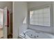 Bright bathroom with a large soaking tub and a separate shower space at 2790 Meadow Gate Way, Loganville, GA 30052