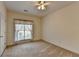 Spacious bedroom featuring neutral carpet, a ceiling fan, and a large window at 2790 Meadow Gate Way, Loganville, GA 30052
