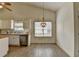 Bright dining area featuring wood-look tile flooring and a charming beaded chandelier at 2790 Meadow Gate Way, Loganville, GA 30052