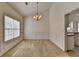 Bright dining room with wainscoting, neutral carpet, and chandelier lighting at 2790 Meadow Gate Way, Loganville, GA 30052