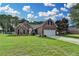 Charming brick home features a well-manicured lawn and attached two-car garage, set beneath a beautiful sky at 2790 Meadow Gate Way, Loganville, GA 30052