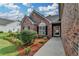 Well-maintained front yard featuring attractive landscaping and a brick facade, adding to the home's curb appeal at 2790 Meadow Gate Way, Loganville, GA 30052