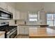 Bright kitchen with stainless steel appliances and island with butcher block top at 2790 Meadow Gate Way, Loganville, GA 30052