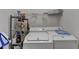 Laundry room featuring white appliances, storage shelves and cleaning supplies at 2790 Meadow Gate Way, Loganville, GA 30052