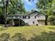 Backyard view of the home with a deck and mature trees at 3840 Whitaker Ln, Lithia Springs, GA 30122