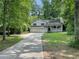 Charming home with a front porch and a large front yard with mature trees at 3840 Whitaker Ln, Lithia Springs, GA 30122