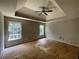 Spacious main bedroom with a tray ceiling and natural light at 3840 Whitaker Ln, Lithia Springs, GA 30122