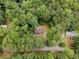 An aerial view of a charming home nestled in a lush green forest, offering privacy and natural beauty at 1010 Martin Ln, Canton, GA 30114
