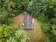 Birds eye view of house surrounded by mature trees, highlighting its secluded and serene location at 1010 Martin Ln, Canton, GA 30114