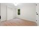 An empty bedroom with light wood floors and a bright window at 1010 Martin Ln, Canton, GA 30114