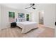 Bedroom featuring a walk-in closet, a light colored rug, and large windows to the outdoors at 1010 Martin Ln, Canton, GA 30114