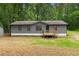 Charming single-story home with a gray exterior and a welcoming front porch at 1010 Martin Ln, Canton, GA 30114