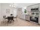 Eat-in kitchen boasts stainless appliances, modern lighting, white cabinets and countertops at 1010 Martin Ln, Canton, GA 30114