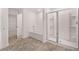 Bathroom featuring a shower with glass doors, a soaking tub, and a doorway to closet at 1406 Gray Branch Dr, Lawrenceville, GA 30045