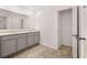 Bathroom featuring double vanity sinks and a walk-in closet with shelving at 1406 Gray Branch Dr, Lawrenceville, GA 30045