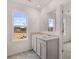 Bright bathroom featuring a double vanity, large mirror, and a view of the outdoors from the window at 1406 Gray Branch Dr, Lawrenceville, GA 30045