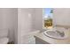 Bright bathroom with a tub and shower combination, double sinks, and a window with a verdant view at 1406 Gray Branch Dr, Lawrenceville, GA 30045