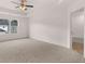 A carpeted bedroom features a ceiling fan and an open door to an ensuite bath at 1406 Gray Branch Dr, Lawrenceville, GA 30045