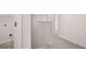 Hallway with view into a laundry room with appliances hookups at 1406 Gray Branch Dr, Lawrenceville, GA 30045