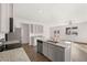 Modern kitchen featuring an island, stainless steel appliances, and sleek gray cabinets at 1406 Gray Branch Dr, Lawrenceville, GA 30045
